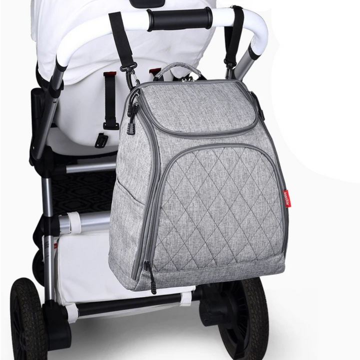 grauer rucksack am kinderwagen befestigt
