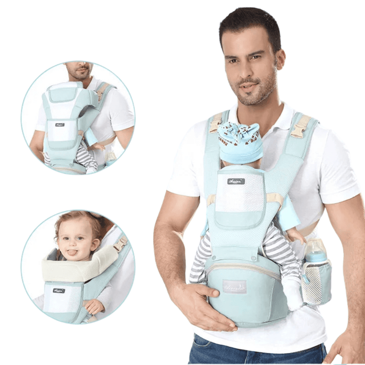 Papa trägt Kleinkind vorwärtsgerichtet in Freya Babytrage mint am Strand